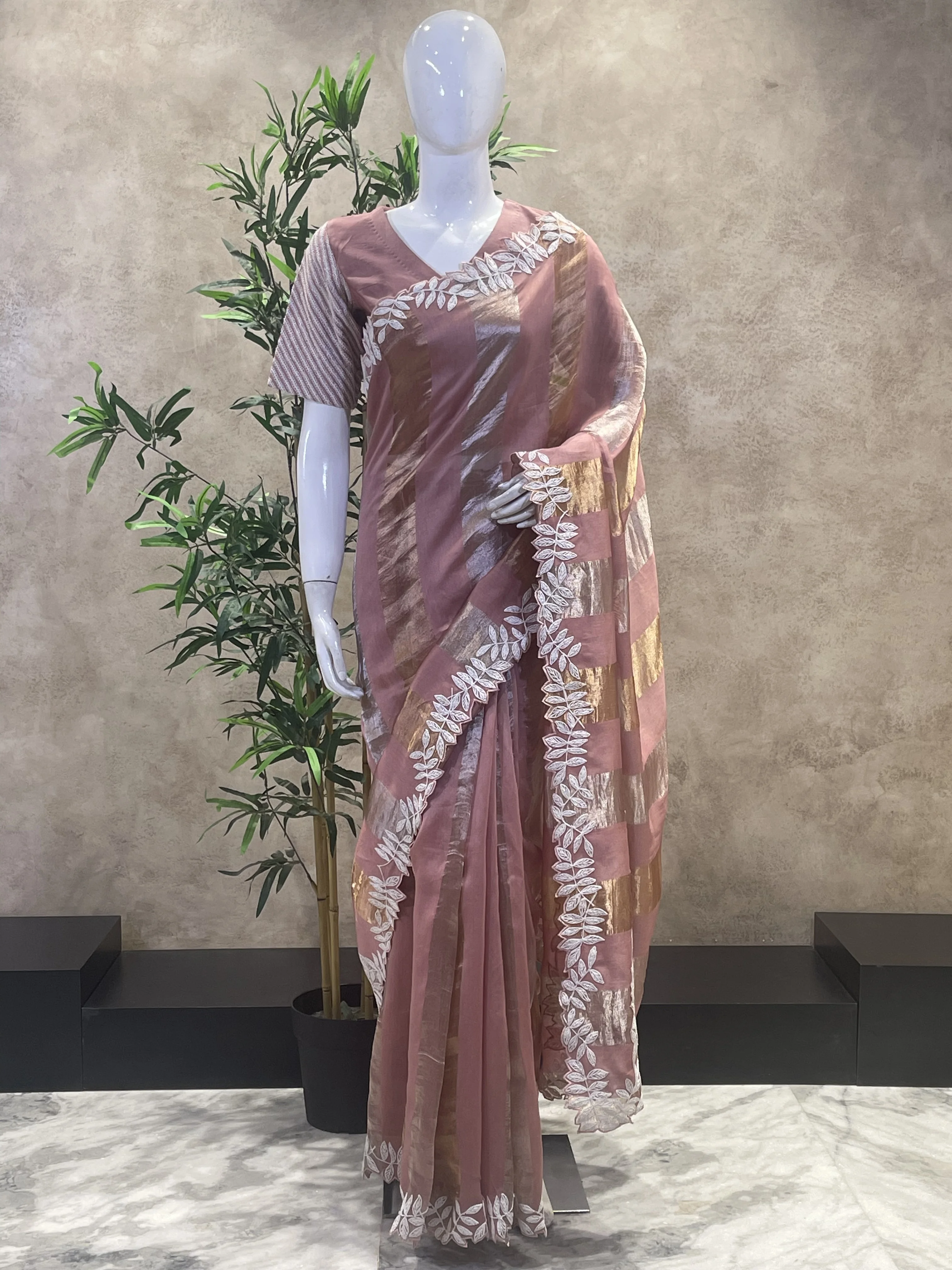 Dusty rose embroidered saree displayed on a mannequin used as input for AI-powered virtual try-on