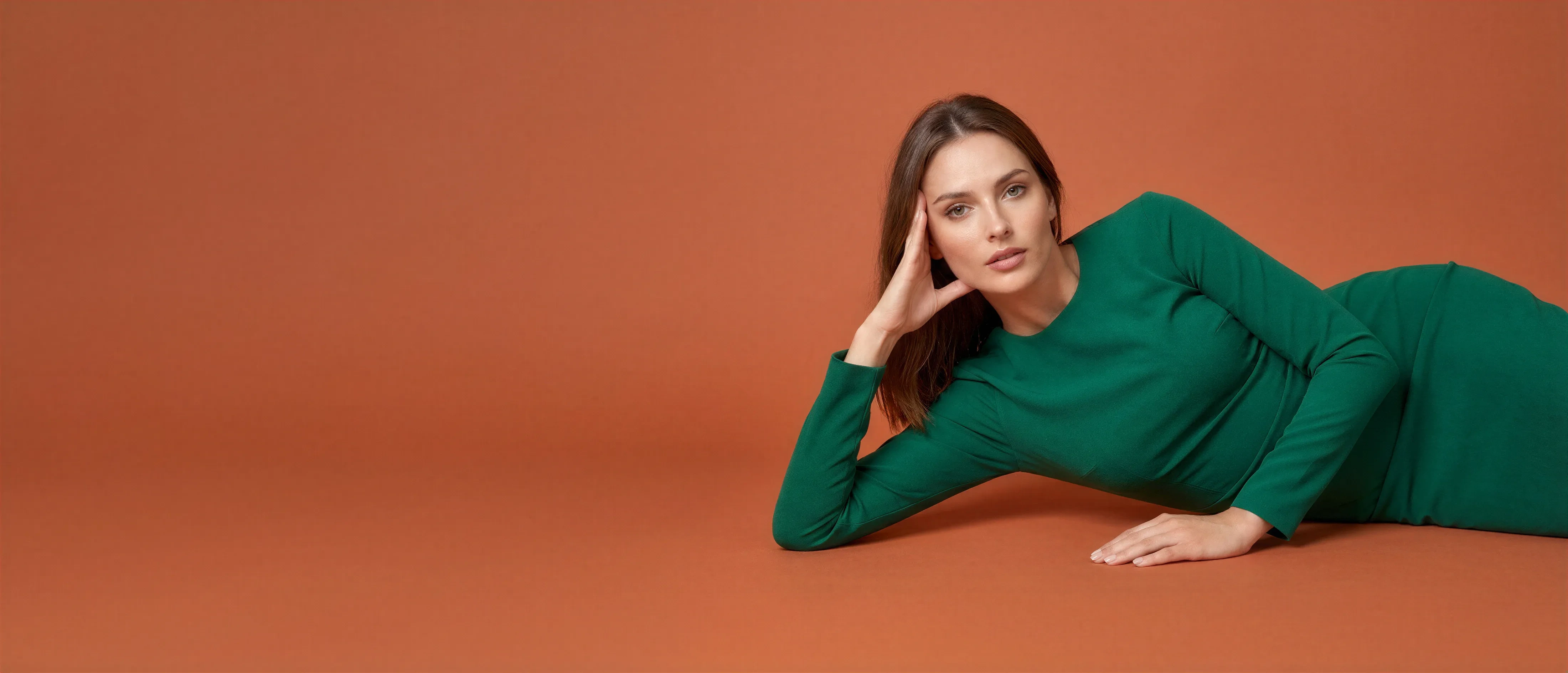 Creative fashion pose of a model wearing a green outfit styled using AI-powered fashion technology.